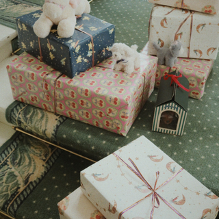 Decorative gift boxes with teddy bears on a patterned surface