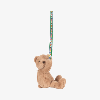 Plush teddy bear bag with a colorful strap on a white background