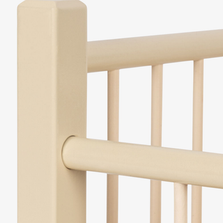 Beige wooden doll bed frame with horizontal bars on a white background