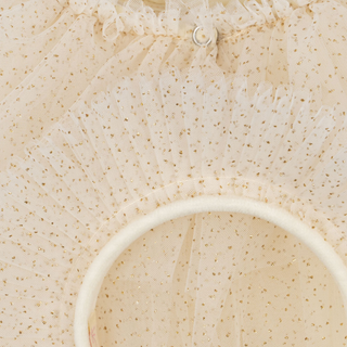 Close-up of a textured beige fabric with a circular cutout