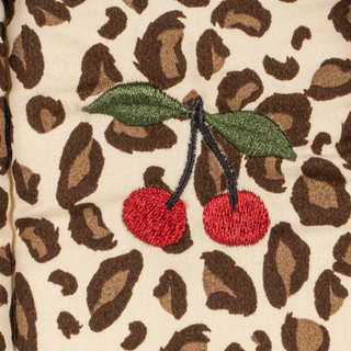 Embroidered cherries on a leopard print fabric