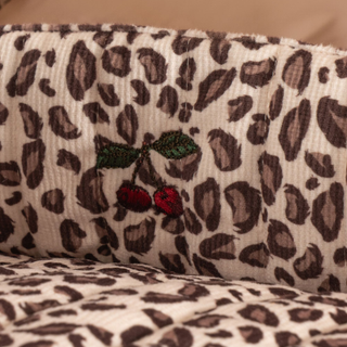 Leopard print fabric with embroidered cherries on a beige background