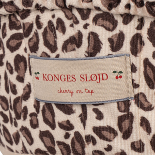 Leopard print fabric with a 'Konges Sløjd' label featuring cherry designs.