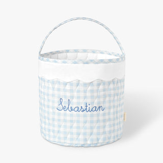 Blue gingham quilted bucket-style basket with scalloped trim and handle.