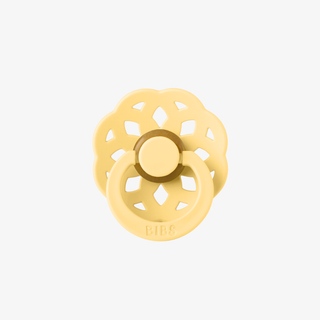 Gold-colored ring holder on a white background