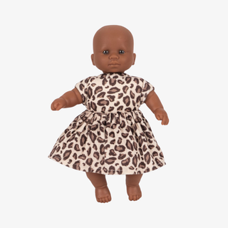 Doll wearing a leopard print dress on a white background