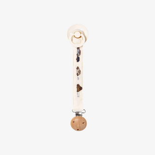 A baby pacifier clip with a cream-colored fabric strap decorated with small vehicle illustrations, featuring a round wooden ball at the bottom and a white plastic clip at the top.