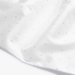 Close-up of a white fabric with small blue dots