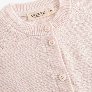 Close-up of a light pink knit cardigan sweater with a ribbed crew neck and three cream buttons, showing the MarMar Copenagen brand label inside the collar.