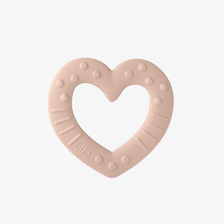 Heart-shaped baby teether with 'BIBS' branding on a light pink background