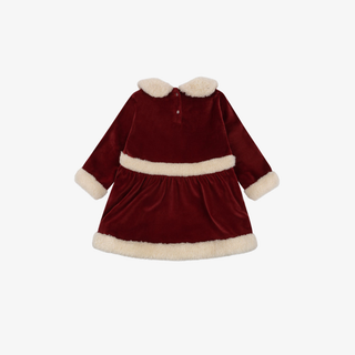 Red velvet dress with white fur trim on a white background