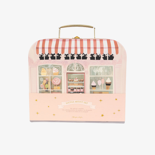 Pink toy box with striped awning and cupcake shop design on a white background