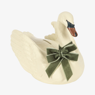 Cream colored swan-shaped money bank with green velvet bow around the neck. 