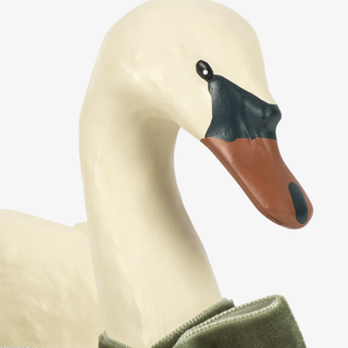 A close-up of a decorative swan figurine wearing an olive green velvet jacket, set against a plain white background.