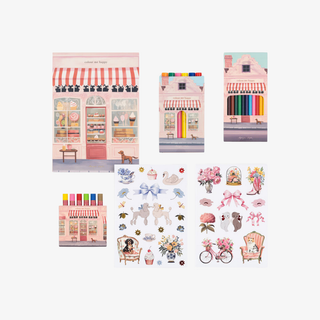 Set of illustrated stationery items including buildings and small scenes on a white background.