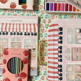 Coloring book set with 'colour me happy' text on a floral background