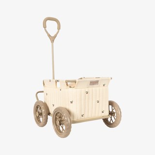 An off-white plastic toy wagon with a beige handle and small cherry details, shown against a light gray background.