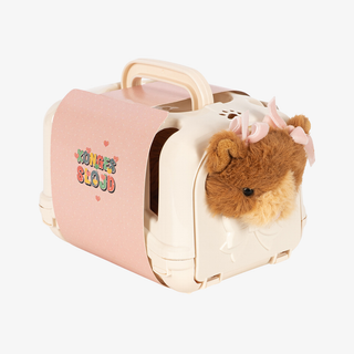 A cream-colored plastic cat carrier with a pink side panel featuring the text 'Konges Slojd' in colorful letters. 