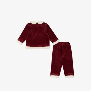 Red velvet outfit with white trim on a white background