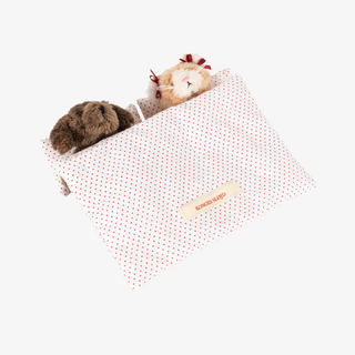 Two plush animal toys peeking out of a toy bed. 