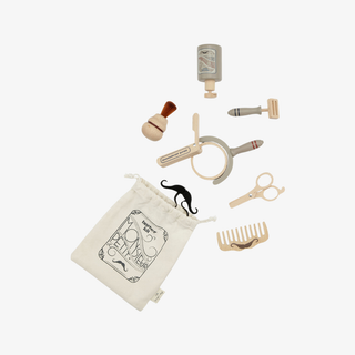 Set of grooming tools including a bottle, brush, clippers, scissors, and a pouch on a white background