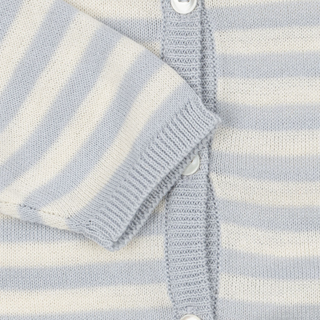 Close-up of a baby outfit with blue and white stripes and buttons.