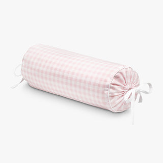 Pink checkered bolster pillow on a white background