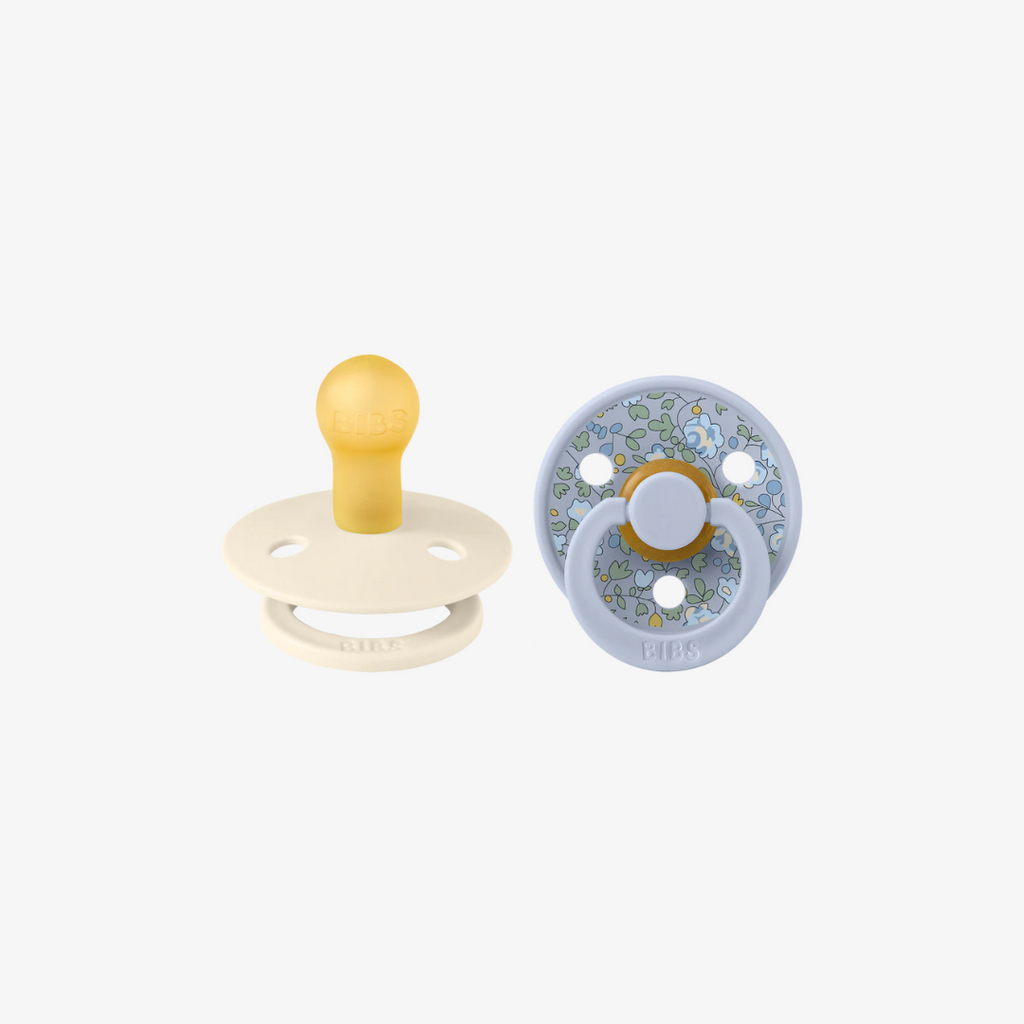 Two baby pacifiers on a white background