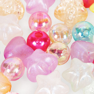 Colorful glass beads including stars and round shapes on a white background