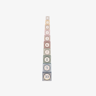 Tall, narrow tower of paper blocks with numbers on a light gray background