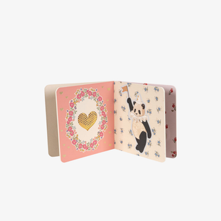 Open book with floral and panda design on a white background