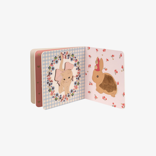 Open book with cartoon rabbit illustrations on a white background