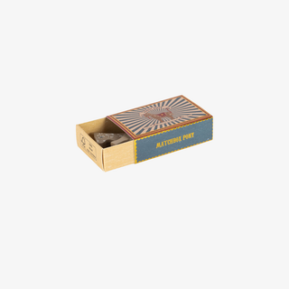 Matchbox with a decorative label on a white background