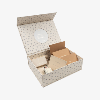 Open gift box with stationery items on a white background