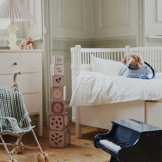 Children's room with a crib, toys, and a baby stroller.