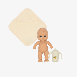 Baby doll with a diaper and sippy cup on a white background