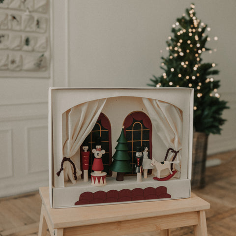 Nutcracker Play Theater wooden box with wooden figurines resting on a wooden bench
