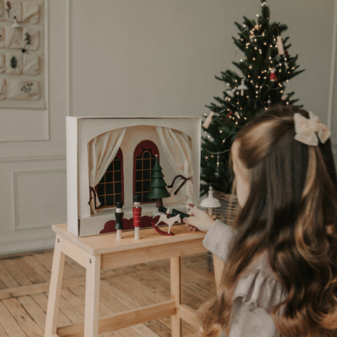 Nutcracker Play Theater wooden box with wooden figurines on bench with little girl facing it