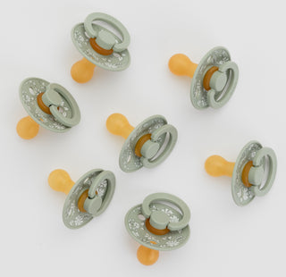 Set of baby pacifiers with GREEN and orange design on a white background