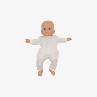 Baby doll wearing a white ribbed outfit on a white background