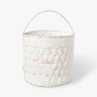 Quilted storage basket with soft pink floral pattern and 'Eloise' embroidery on a white background
