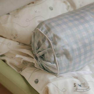 picnic gingham blue bolster pillow with cartoon designs on a neutral background