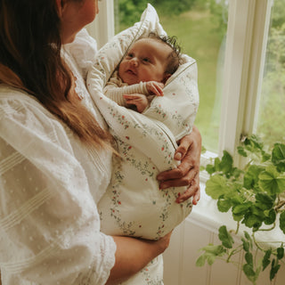Botanical Berries Baby Duve wrapped around baby in mothers arms