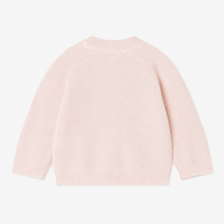 A light pink knit sweater with long sleeves, shown from the back against a plain white background.