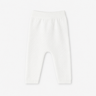 White textured knit baby leggings with an elastic waistband, shown flat against a light gray background.
