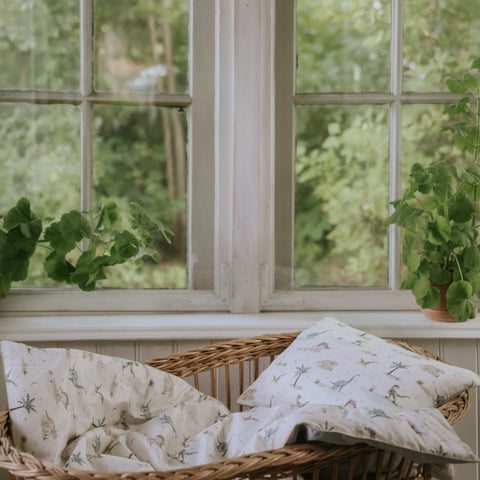 Dino Dreams Baby Duvet in Sage in bassinet
