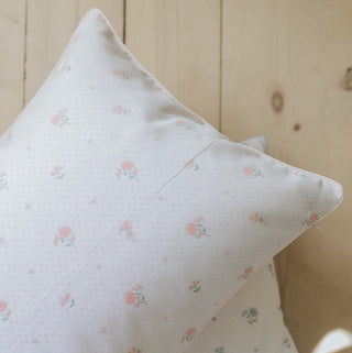 Close up on standard pillow in ditsy pink floral. 
