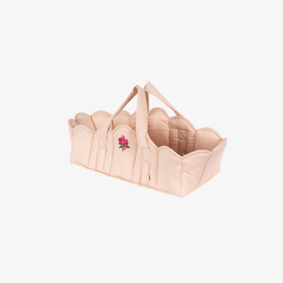 Pink baby carrier with floral design on a white background