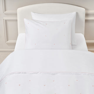 White duvet and pillow sham with pink embroidered hearts details.