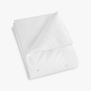 White toddler duvet with embroidered blue star patterns on a white background